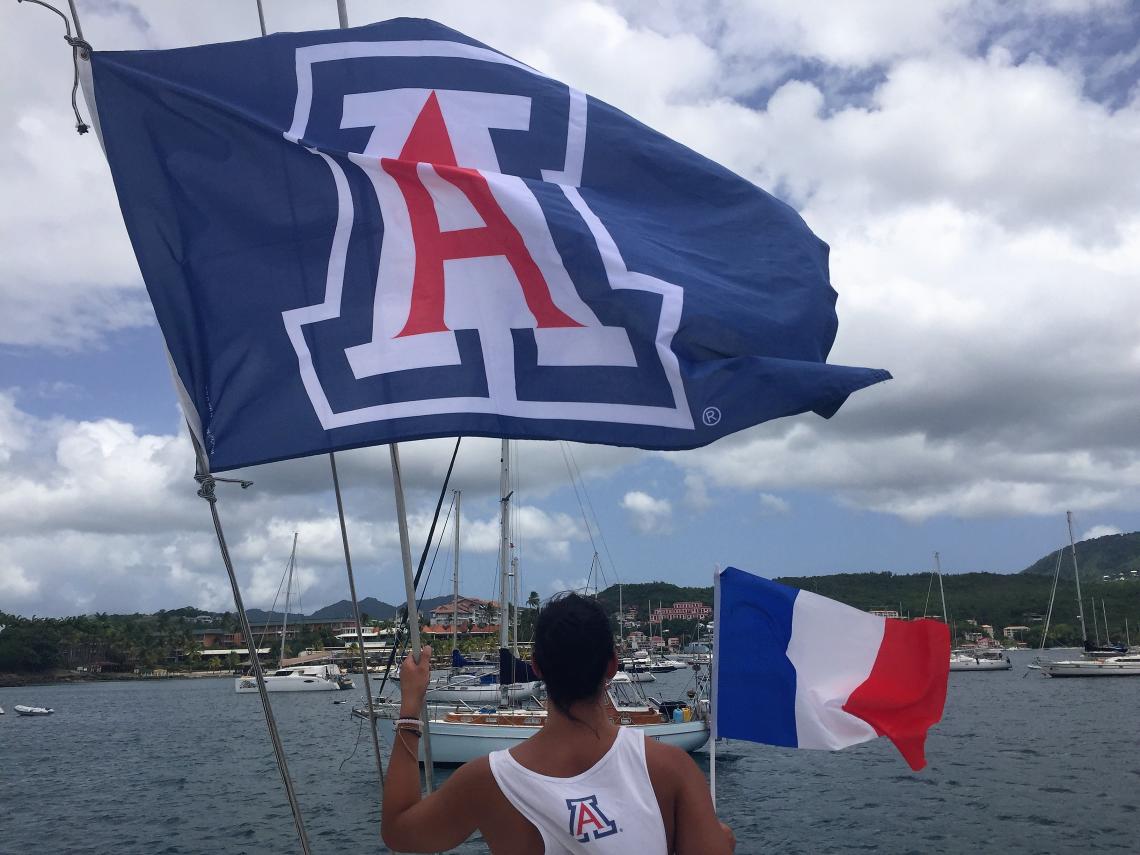 Student Rachel Franke flies the UA flag in Martinique during the Arizona in the French Caribbean Program, run through the College of Humanities with support from UA Study Abroad in the Office of Global Initiatives. Student Rachel Franke flies the UA flag in Martinique during the Arizona in the French Caribbean Program, run through the College of Humanities with support from UA Study Abroad in the Office of Global Initiatives.